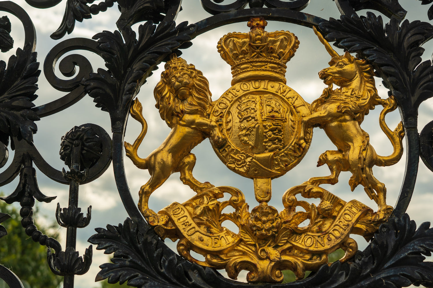 A wrought iron gat with a golden top, fashioned to resemble a lion and a unicorn, symbols of England, the inspirations for the title to George Orwell's essay The Lion and The Unicorn: Socialism and The English Genius (Photo by Nick Fewings on Unsplash)